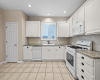 Charming eat in kitchen with newly painted cabinets and granite counters