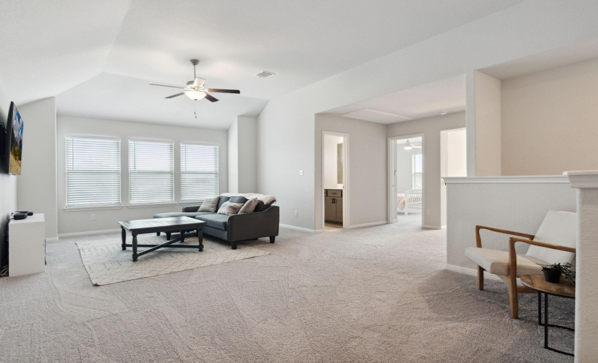 This spacious second-level landing area offers an expansive and versatile space, perfect for transforming into a game room or a secondary living area.