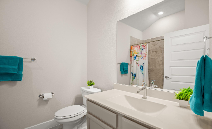  Step into the stylish guest bathroom, designed with modern fixtures and tasteful finishes to provide a comfortable and inviting space for guests.