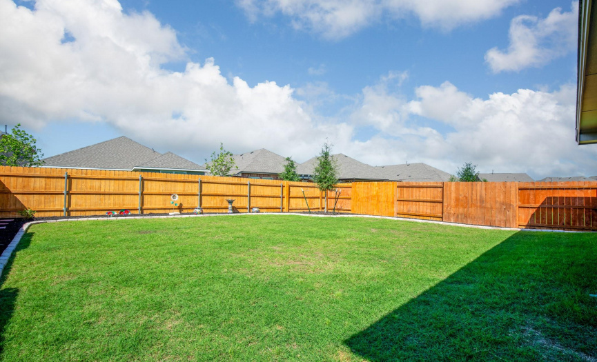 Surround yourself with the beauty of nature in the backyard, featuring meticulously maintained landscaping that provides a peaceful backdrop for outdoor activities.