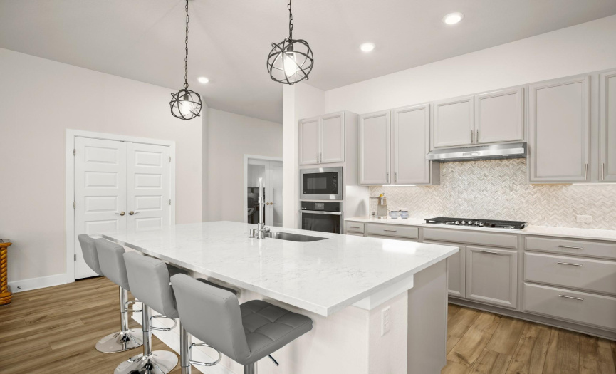 Experience culinary excellence in the chef's kitchen, equipped with high-end stainless-steel appliances including a gas cooktop and a built-in oven with an air fry setting.
