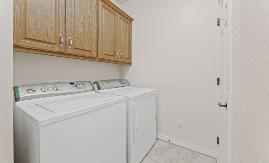 Laundry Room with upper cabinets, utility closet and counter - the washer & dryer convey!