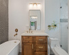 Primary bedroom full bath features updated vanity, mirror, fixtures and soaking tub.