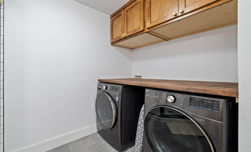 Laundry area with built-in cabinet storage and tabletop!