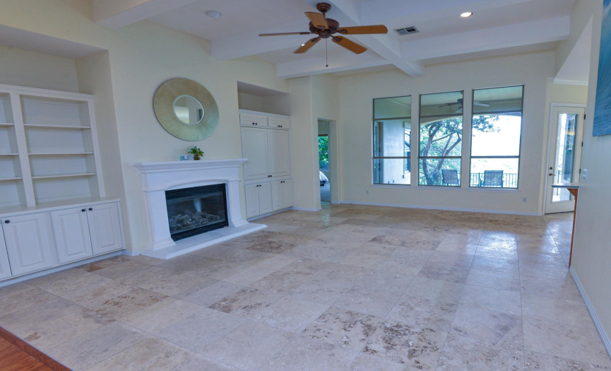 This nice sized FAMILY RM enjoys gorgeous Travertine Stone Floors AND a view of the greenbelt. 