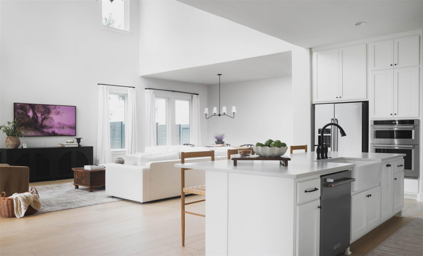 The kitchen's strategic placement allows for seamless interaction with the living and dining areas, fostering a sense of togetherness and ensuring that no moment is missed while entertaining or spending quality time with family and friends
