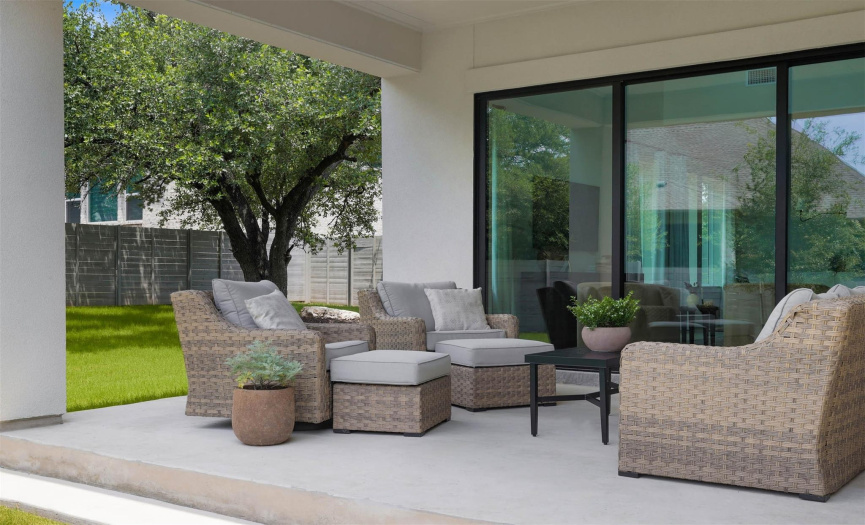 Outside, the covered patio and sizable backyard create an inviting space for outdoor gatherings and entertainment