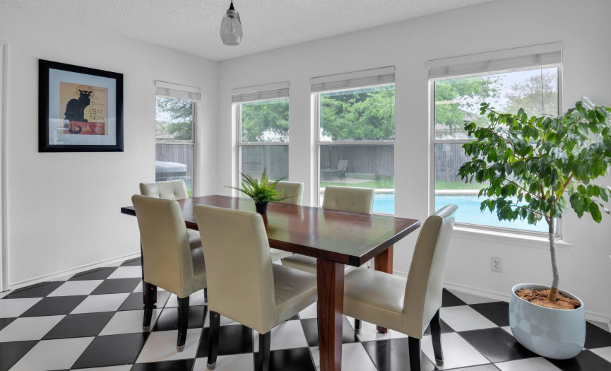 A large breakfast nook sits just off the kitchen and overlooks the pool and backyard.