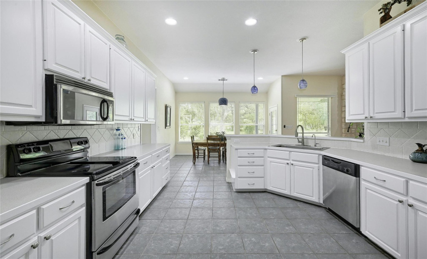 Stainless appliances and hearty tile grace the kitchen making it easy to entertain.