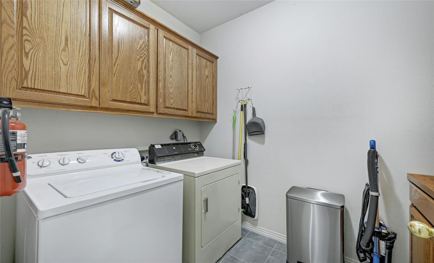 Laundry room with built-ins on both sides gives you plenty of storage.