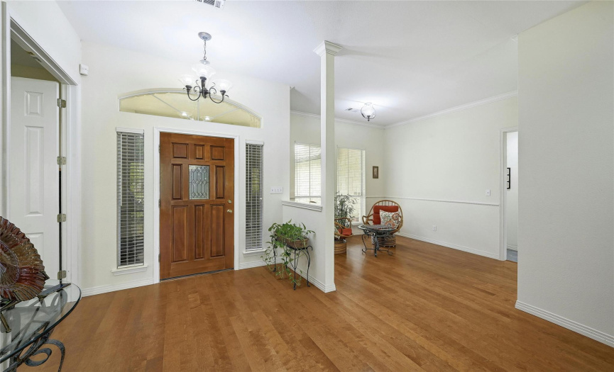 These beautiful hardwood floors shine!  The bright and inviting foyer is open to the main living, the formal dining and the 4th bedroom/office.
