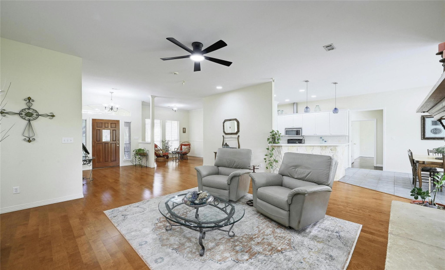 Beautiful hardwood floors grace the open living and formal dining areas.  There is plenty of room for a full living room set here plus your entertainment center.