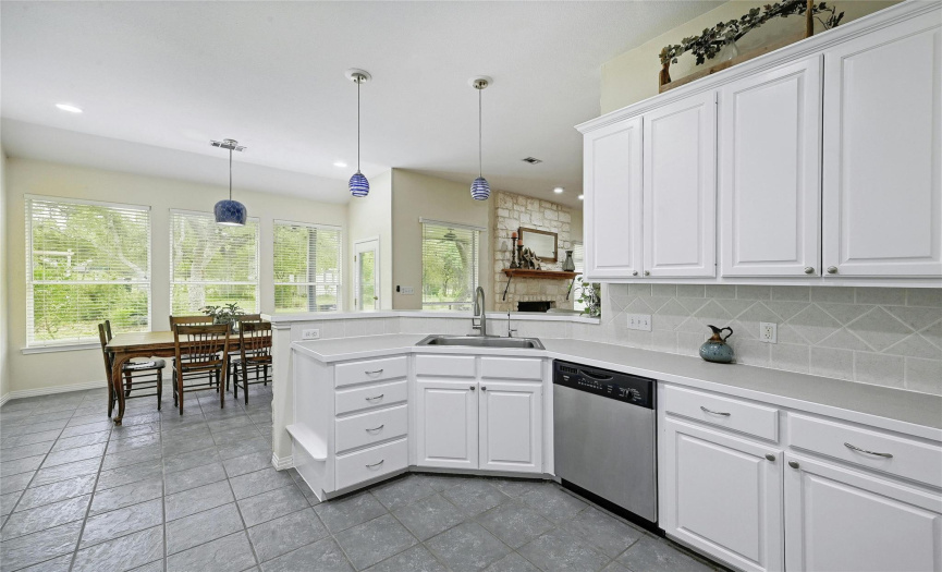 Light and bright and ready to cook!  This kitchen has a view of the back yard oasis and is open to the living area.  Enjoy coffee and meals in your spacious breakfast nook with access to the back patio.