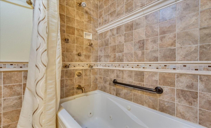 The deep jetted tub is a rare luxury in a condo – and so is the full-body shower system with wall jets! 