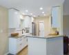 Kithen with recessed lighting, grantie countertops and stainless steel appliances. 