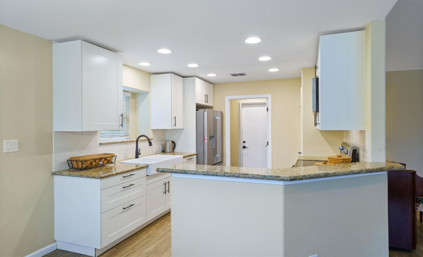 Kithen with recessed lighting, grantie countertops and stainless steel appliances. 