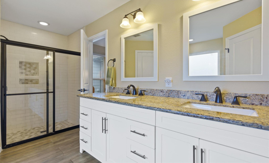 Primary bathroom with double vanity, 2 primary closets, separate tub and shower