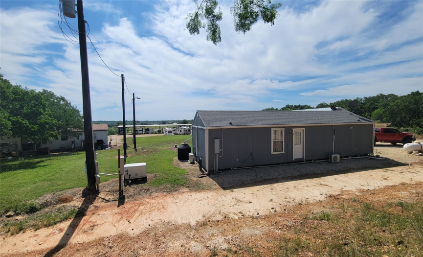 Office Building sits at the back of property.  See the Manufactured Home to the left just in front of Office.