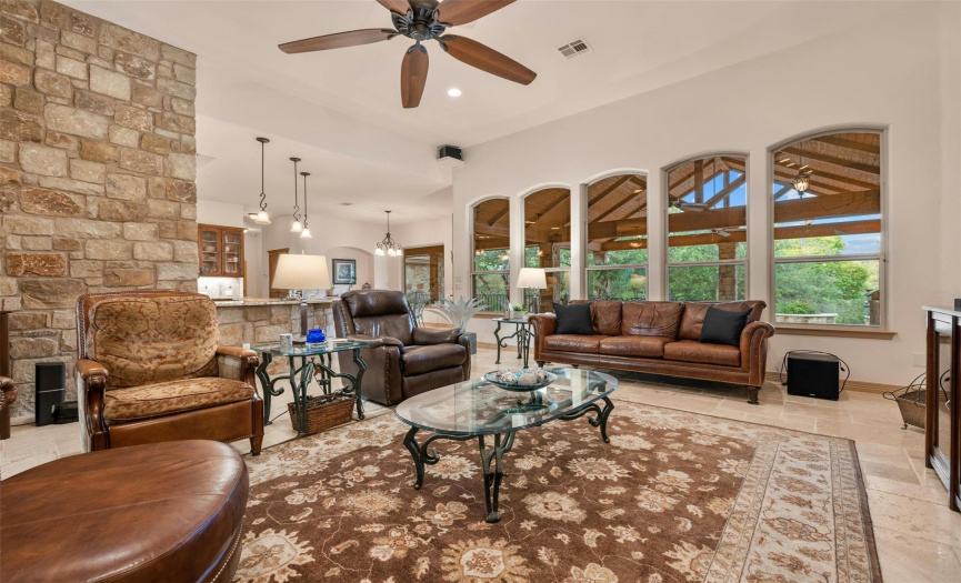 From the family room, breakfast room, and kitchen, the view of the massive, vaulted covered back patio and pool through the arched windows is fantastic. There are 18 arched doors, ceilings, vestibules, and windows throughout the home interior.