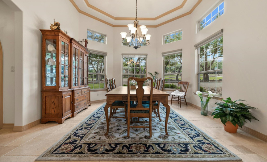 This large formal dining area has an extra high coffered ceiling, lots of windows for natural light, and motorized window shades. The bay window has been extended out an additional two feet.