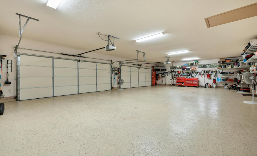This four car garage has an epoxy floor and has been expanded 5 feet in length and width for increased room and storage. 300 pound test strength Saferacks heavy duty shelving, plus Sears Versa Track hooks and bins are installed in wall studs for enormous amount of storage space.
