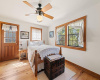 Primary bedroom has an exterior entrance, Pine floors, lots of natural light from the large windows.