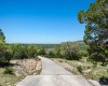 Paved drive from entry to the house, guest house, studio, storage barn. Again…those views!