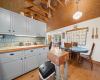 Inviting kitchen boasts Pine floors, bead board ceiling and exposed beams, also.