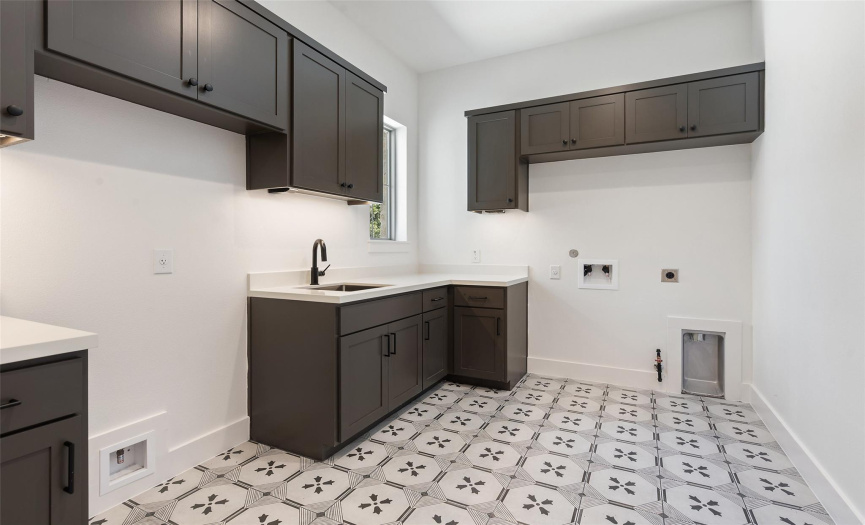 oversized laundry room with space for fridge, ample storage, and ready for gas or electric dryer