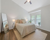 Primary bedroom feels light and airy with vaulted ceilings and abundant natural light.