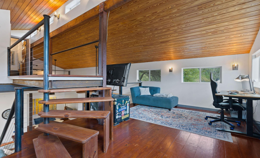 The upstairs loft with stairs to another bathroom and laundry room.