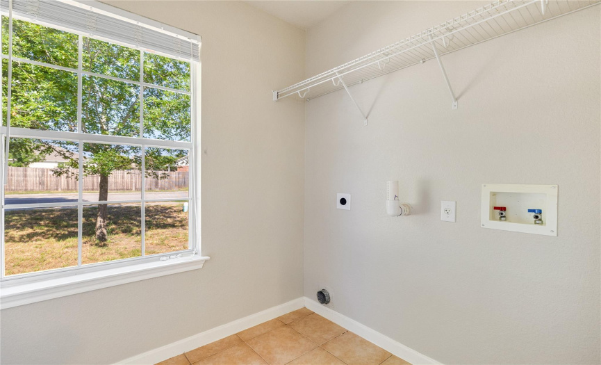 The laundry room features convenient amenities and ample storage, making household chores a breeze while adding efficiency to your daily routine.