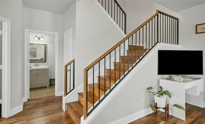Perfectly positioned staircase that offers a coat closet and extra storage. 