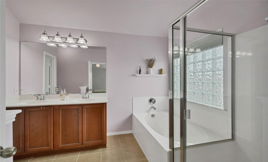 The en-suite bath offers convenience and comfort with double vanity, soaking tub and separate, walk-in shower.