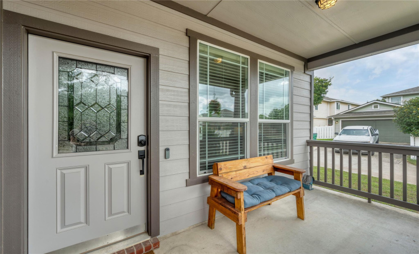 Rain or shine, this spacious, covered front porch offers the right space for relaxation.