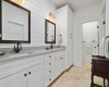 Primary bathroom in home number one has dual vanities, shiplap walls and more.