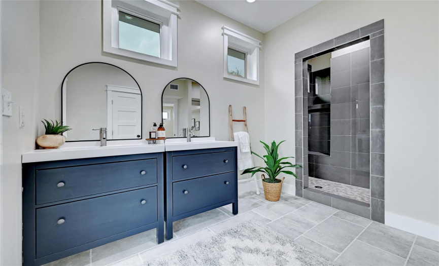 Now this is a bathroom that you'll enjoy getting ready in each day.  The bathrooms in the home have all been beautifully updated to reflect modern tastes using on-trend materials like textured subway tile, large-format tile, and richly painted vanities.   
