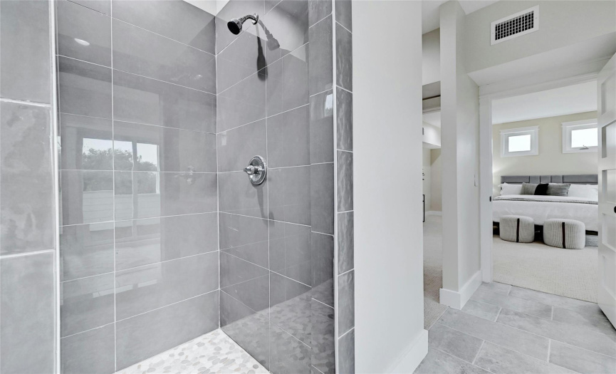 The spacious shower in the primary bathroom provides a spa-like experience.