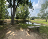 Shaded bench next to relaxing pond on 3.42 acre Lot 4, 117 Saddle court dr. That's 3.42 aces with power and water, flat, cleared and ready to build on!