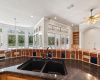 Photo of Decorative Tile Backsplash, Granite Counter and View to Family, Dining and Flex Rooms - Also panoramic view of the back yard and beyond