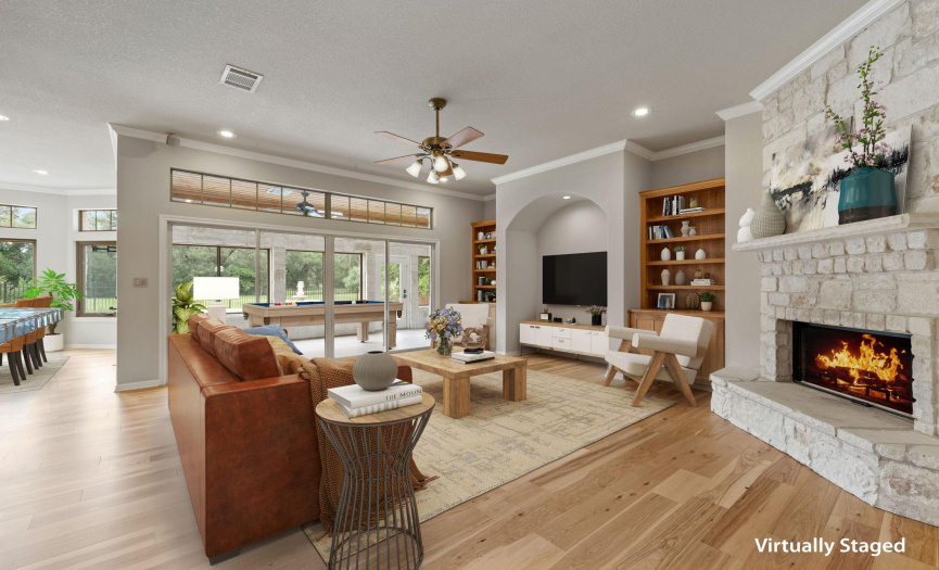Relax in the Family Room with the Floor to Ceiling fireplace, Built-in bookcases, recess alcove for your TV and the newly installed wood flooring.