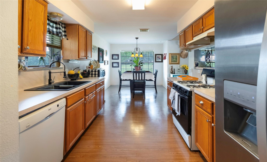 The kitchen is a chef's delight with ample cabinet space, a dining area, and a convenient gas stove for cooking up your farm-fresh meals. 
