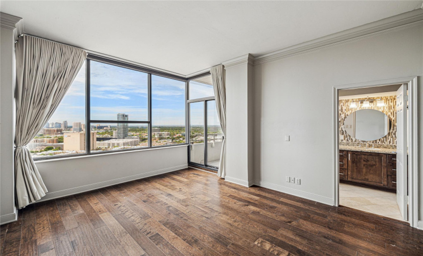 The secondary bedroom also showcases Northwest views over Houston. There is an en-suite bathroom, adjacent closet, and access to the second balcony.