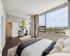 The opposite angle of the Primary Bedroom; note the dazzling views over Houston from this top-floor penthouse. Virtually staged.