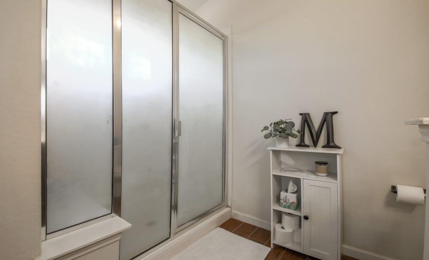 A sizeable walk-in shower with sitting space, the perfect place to unwind after a long day.