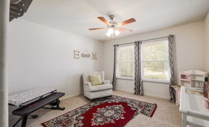 Another nice-sized bedroom with a ceiling fan and great natural light throughout.
