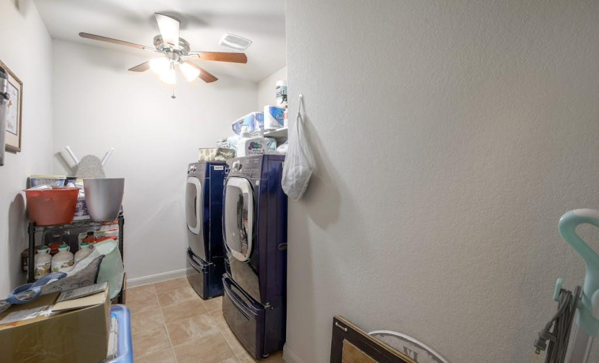 The laundry room has tile flooring, a ceiling fan, and washer/dryer connections.