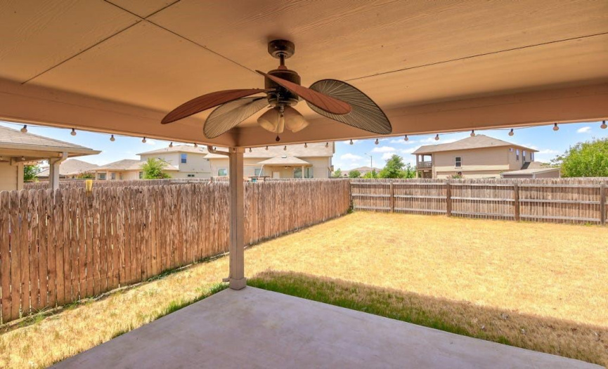 The covered patio overlooks the backyard and includes a ceiling fan that is sure to keep you cool during the warmer months.