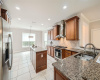 Kitchen with granite counters with stainless steel GE Monogram appliances