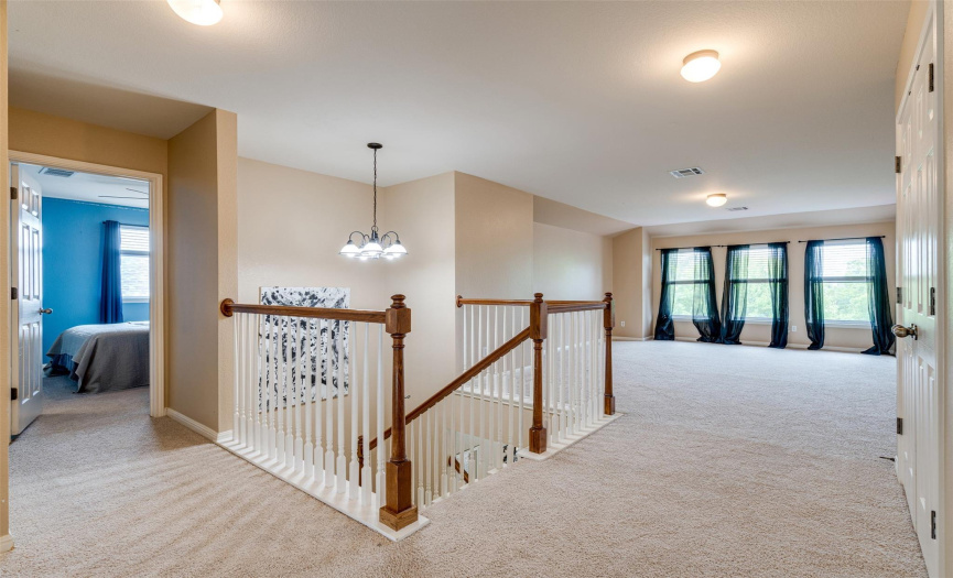 Ascend to a gracious extra living room located upstairs – a versatile space designed for relaxation and entertainment. 